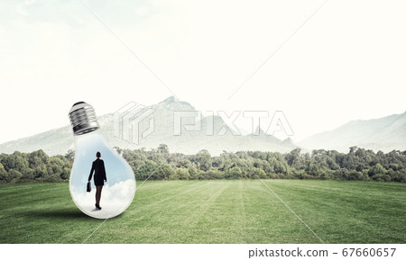 Businesswoman inside light bulb 67660657