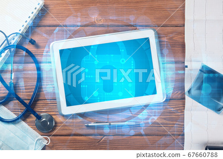 Top view of doctor workplace with tablet pc and medicine tools on wooden table Top view of doctor workplace with tablet pc and medicine tools on wooden table 67660788