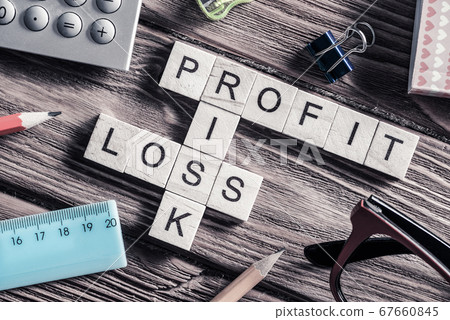 Profit loss and risk words on workplace collected of wooden cube Profit loss and risk words on workplace collected of wooden cube 67660845