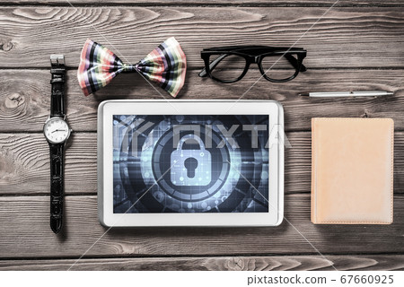 Gentleman kit of tablet watch glasses and notebook on wooden table 67660925