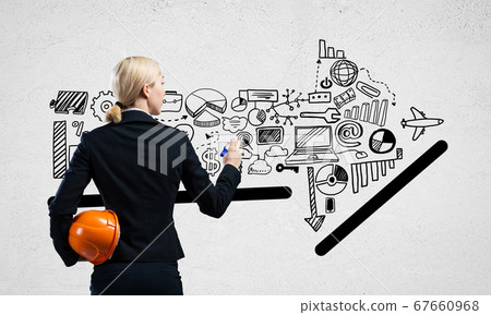 Businesswoman draws various business infographics Businesswoman draws various business infographics 67660968