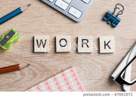 Elements of game with letters spelling business keywords on workplace 67661072