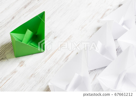 Business leadership concept with white and color paper boats on wooden table 67661212
