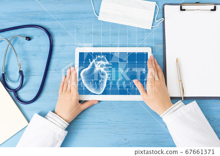 Top view of doctor hands with tablet computer Top view of doctor hands with tablet computer 67661371