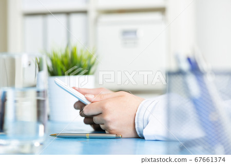 Close up of doctor hands using tablet computer Close up of doctor hands using tablet computer 67661374