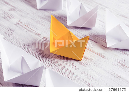 Business leadership concept with white and color paper boats on Business leadership concept with white and color paper boats on 67661375