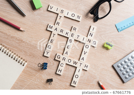 Conceptual business keywords on table with elements of game making crossword Conceptual business keywords on table with elements of game making crossword 67661776
