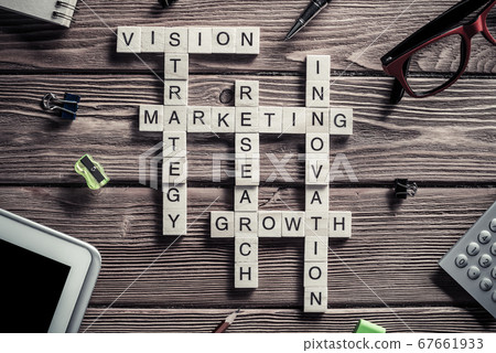 Conceptual business keywords on table with elements of game making crossword Conceptual business keywords on table with elements of game making crossword 67661933