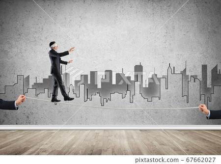 Business concept of risk support and assistance with man balancing on rope Business concept of risk support and assistance with man balancing on rope 67662027