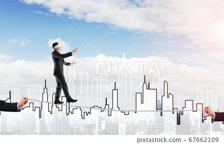 Business concept of risk support and assistance with man balancing on rope Business concept of risk support and assistance with man balancing on rope 67662109