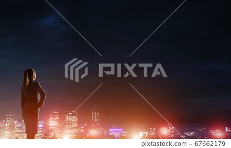 Woman looking at night city 67662179