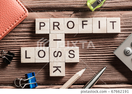 Profit loss and risk words on workplace collected of wooden cubes Profit loss and risk words on workplace collected of wooden cubes 67662191