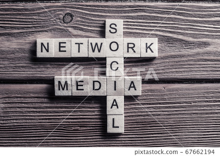 Conceptual media keywords on table with elements of game making crossword Conceptual media keywords on table with elements of game making crossword 67662194