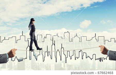 Business concept of risk support and assistance with man balancing on rope Business concept of risk support and assistance with man balancing on rope 67662468