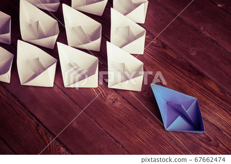 Business leadership concept with white and color paper boats on Business leadership concept with white and color paper boats on 67662474