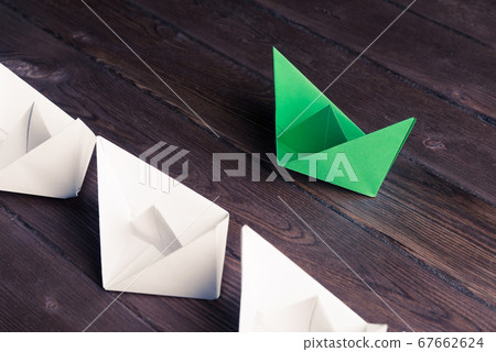 Business leadership concept with white and color paper boats on 67662624