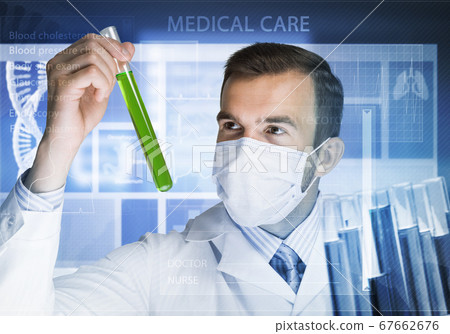 Portrait of concentrated male scientist working with reagents in laboratory 67662676