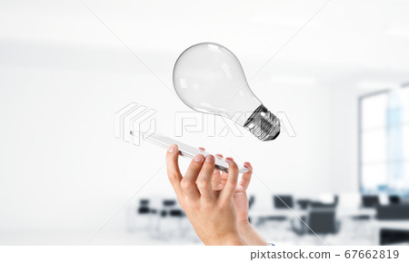 Light bulb as concept for power or idea. Mixed media Light bulb as concept for power or idea. Mixed media 67662819