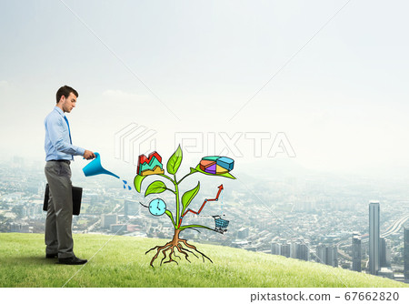 Young businessman outdoors watering drawn growth concept with can Young businessman outdoors watering drawn growth concept with can 67662820