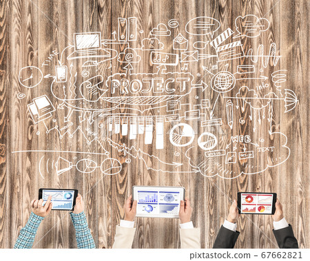 Top view of businesspeople sitting at table and using gadgets Top view of businesspeople sitting at table and using gadgets 67662821