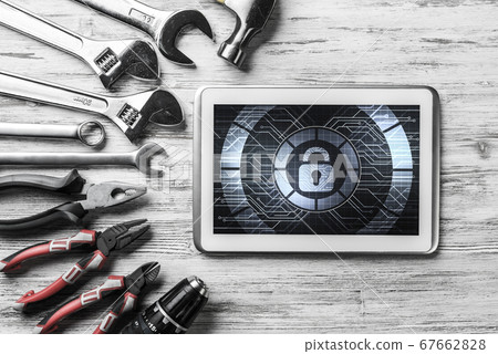 Web security and technology concept with tablet pc on wooden table Web security and technology concept with tablet pc on wooden table 67662828