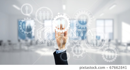 Teamwork concept and choosing gesture of businessperson in elegant modern interior Teamwork concept and choosing gesture of businessperson in elegant modern interior 67662841