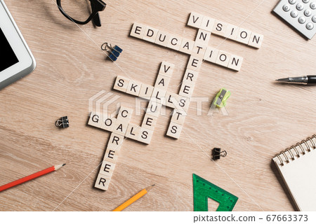 Conceptual keywords on wooden table with elements of game making crossword Conceptual keywords on wooden table with elements of game making crossword 67663373