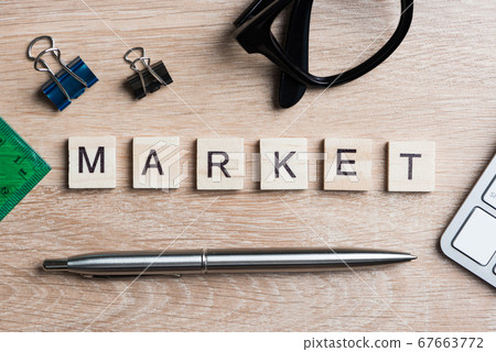Office stuff and SELL word spelled with wooden blocks on workplace table Office stuff and SELL word spelled with wooden blocks on workplace table 67663772
