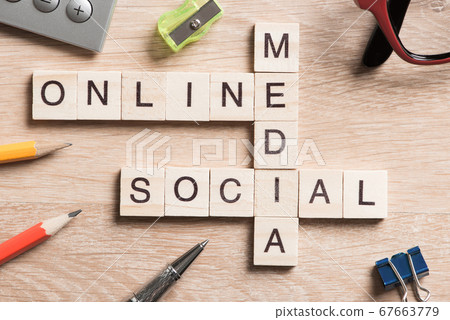 Conceptual media keywords on table with elements of game making crossword Conceptual media keywords on table with elements of game making crossword 67663779