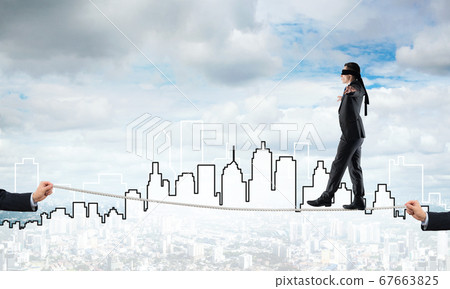 Business concept of risk support and assistance with man balancing on rope 67663825