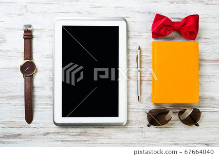 Gentleman kit of tablet watch glasses bow tie and notebook on wooden table 67664040