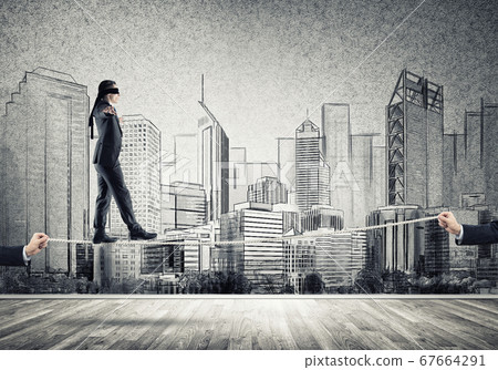 Business concept of risk support and assistance with man balancing on rope Business concept of risk support and assistance with man balancing on rope 67664291