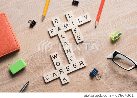 Conceptual keywords on wooden table with elements of game making crossword Conceptual keywords on wooden table with elements of game making crossword 67664301