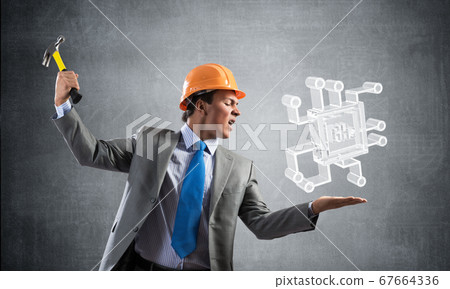 Furious businessman going to crash glass microchip Furious businessman going to crash glass microchip 67664336