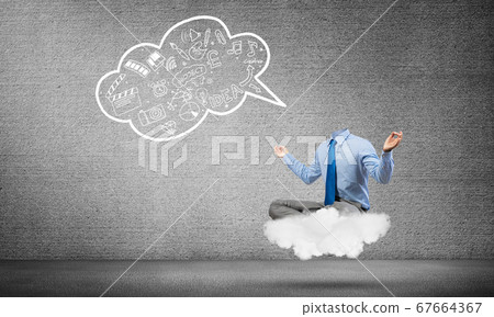 Headless businessman meditating 67664367