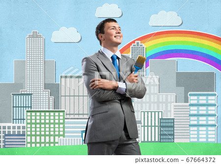 Creative businessman painter holding paintbrush Creative businessman painter holding paintbrush 67664372