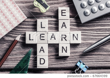 Conceptual keywords on wooden table with elements of game making crossword 67664399