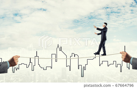 Business concept of risk support and assistance with man balancing on rope Business concept of risk support and assistance with man balancing on rope 67664796