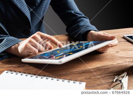Businesswoman using tablet computer at desk Businesswoman using tablet computer at desk 67664926