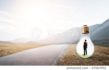 Businessman inside light bulb 67664992