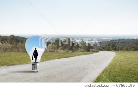 Businesswoman inside light bulb 67665199
