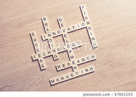 Conceptual media keywords on table with elements of game making crossword Conceptual media keywords on table with elements of game making crossword 67665205