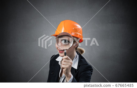 Technical inspector looking through magnifier 67665485