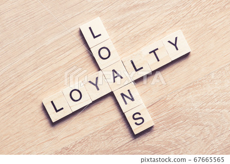 Conceptual business keywords on table with elements of game making crossword 67665565