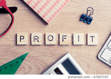 Office stuff and profit word spelled with wooden blocks on workplace Office stuff and profit word spelled with wooden blocks on workplace 67665597