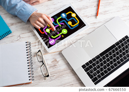 Business lady using tablet computer at desk Business lady using tablet computer at desk 67666550