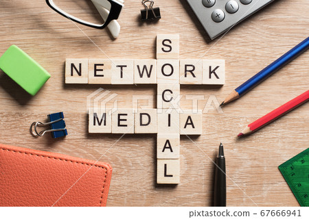 Conceptual media keywords on table with elements of game making crossword 67666941