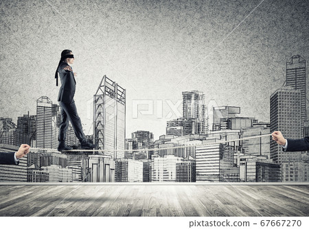 Business concept of risk support and assistance with man balancing on rope 67667270