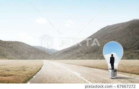 Businessman inside light bulb 67667272