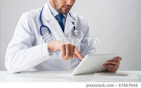 Close up of therapist hands using tablet computer Close up of therapist hands using tablet computer 67667648